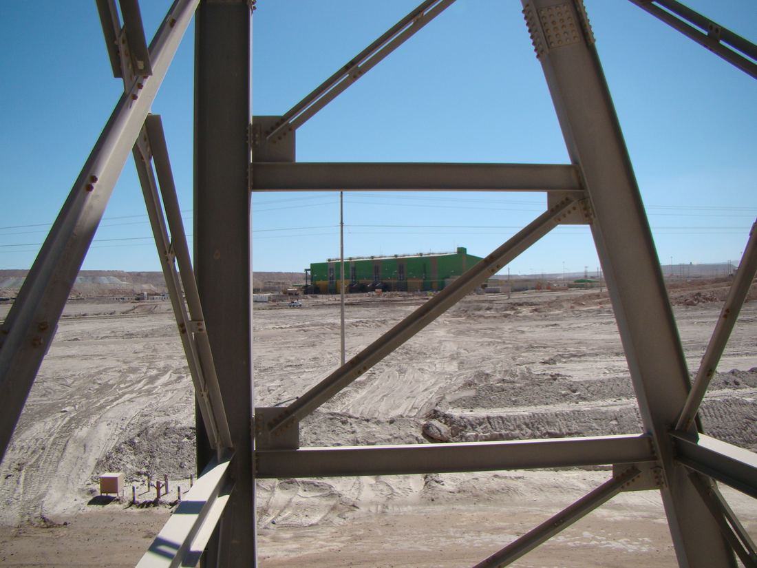 Vista de una planta industrial a través de una estructura metálica
